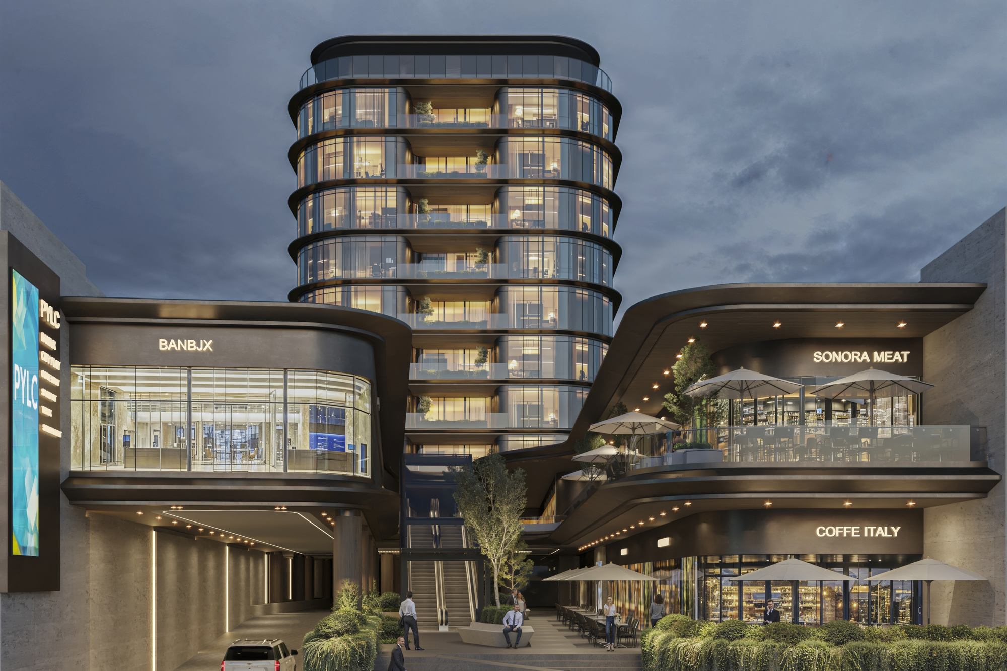 Parque Corporativo PYLC al anochecer: torre de oficinas iluminada sobre la plaza comercial